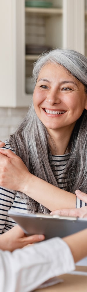 GrandView Asset Management Financial Services Banner featuring older woman discussing investment strategies with our team